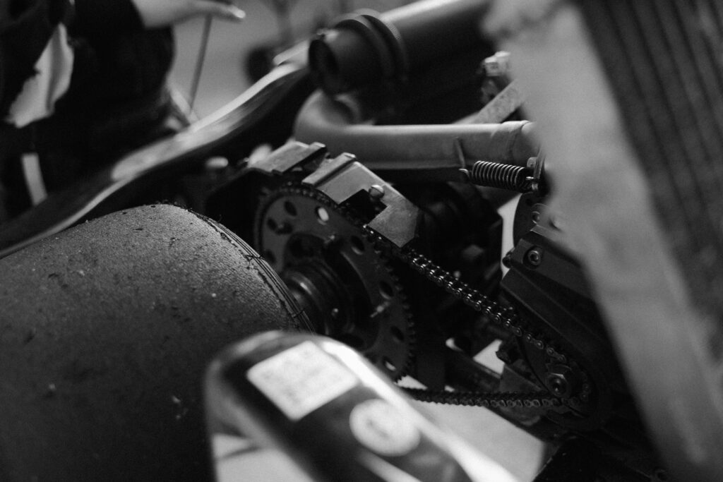 Detailed black and white photos showing kart engine, chain, and mechanical parts.